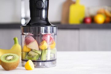 Hand blender for mixing organic raw fresh fruits for making vitamin diet smoothie, healthy food,...
