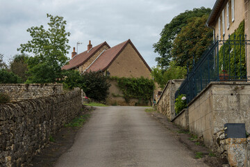 Fototapeta na wymiar road with old houses and walls in the ancient village of Vareilles in the region Brionnais in France