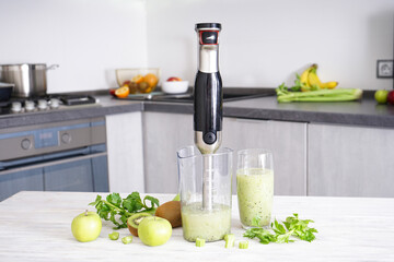 Hand blender for mixing organic raw fresh fruits for making vitamin diet smoothie, healthy food.