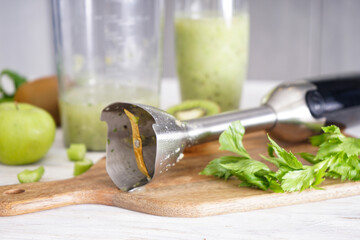 Hand blender for mixing organic raw fresh fruits, healthy food.