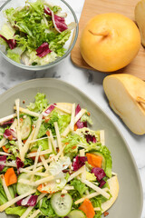 Delicious turnip salad served on white marble table, flat lay