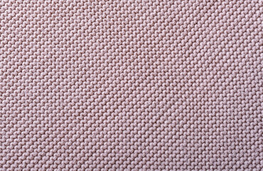 Fototapeta premium The texture of a beautiful knitted fabric. The pattern is clearly visible.