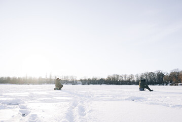 Winter ice fishing on a bright sunny day