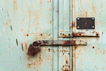 Old rusty green metal door with barn lock background texture background wallpaper