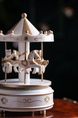 White vintage toy carousel with horses