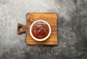 Tomato sauce on the wooden. Grey background. Top view.