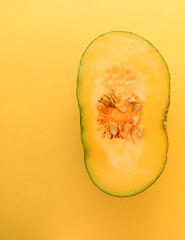 pumpkin slice isolated on a yellow background, with copy space