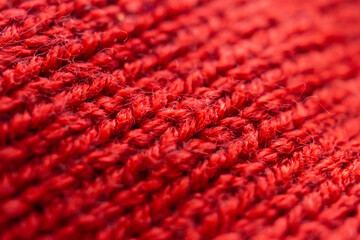 closeup red knitted woolen fabric texture background
