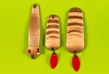 A set of fishing spinners on a green background.