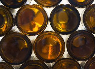 Staple of brown empty glas bottles
