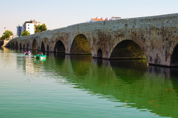 Fototapeta premium Picturesque landscape view of ancient roman bridge over Seyhan River in Adana. Famous touristic place and travel destination in Adana