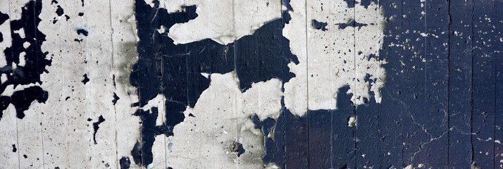 Fototapeta premium dark blue paint peeling on stone wall