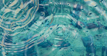 3d rendering. Surface of blue water with a stone bottom and ripples on the surface from raindrops.
