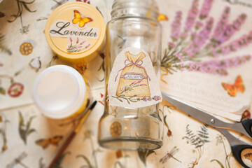 Decoupage process with a glass jar. Glue, brush, scissors and paper napkins. Top view. Creativity, DIY background