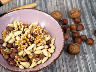 Mix nuts on a wooden background.