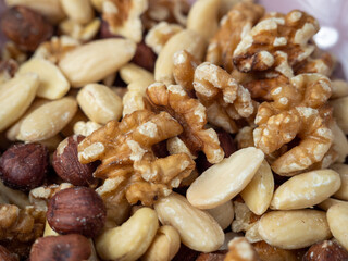 Mix nuts on a wooden background.