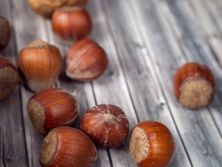 Hazelnuts on a wooden background.