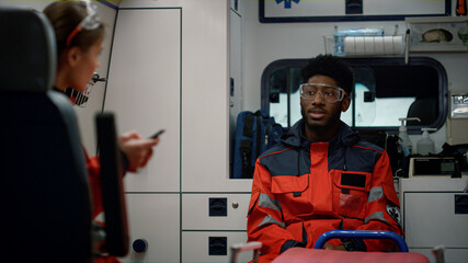 Emergency care assistants driving in ambulance car for traffic accident © stockbusters