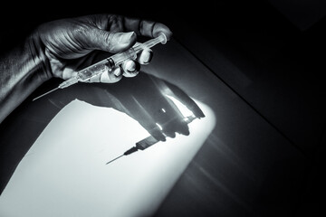 Drug addict arm with syringe in hand, closeup syringe and arm, junkie overdose  - obrazy, fototapety, plakaty