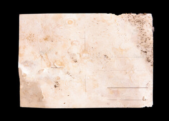 The back side of an old postcard, almost destroyed, worn and faded, with lots of blank space to fill with your content, isolated on a black background.
