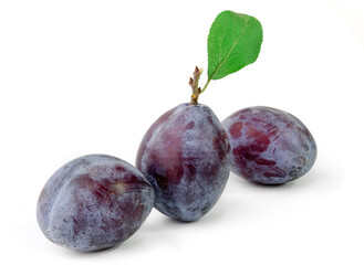 Group of plums with leaf isolated on a white background