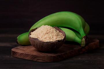 Green banana flour, on a wooden table, healthy food, selective focus, rustic style, horizontal, no people, © Gala_Didebashvili