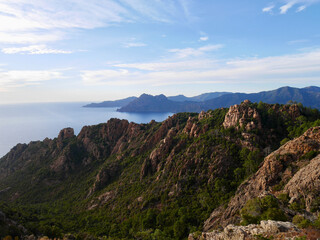 Red cliffs at the Calanche de Piana, UNESCO world heritage, at sunset. Corsica, France.