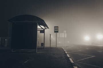 Lonely empty bus stop at foggy night