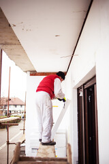 Naklejka na ściany i meble Construction site - Installing external insulation Facade therm