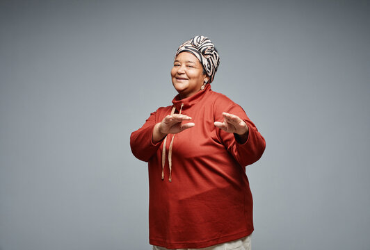 Waist Up Portrait Of Carefree Black Senior Woman Dancing Against White Background, Copy Space