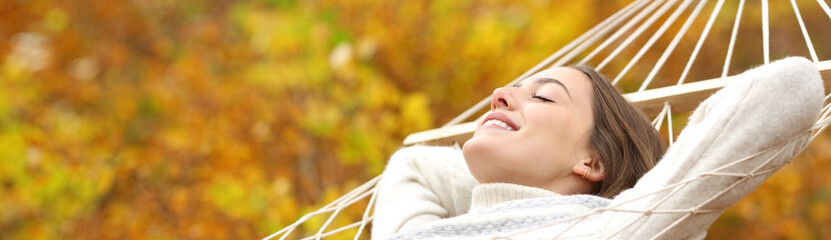 Banner of a happy woman relaxing on hammock in autumn