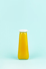 Bottle of lemon juice and fresh lemons. Juice glass bottle