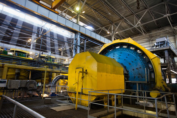 Copper ore concentration plant interior. Factory ball mill and yellow tanks on background. Khromtau, Kazakhstan. 