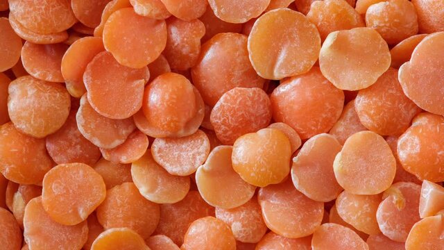 Lentils orange close-up, moving sideways, macro, top view.