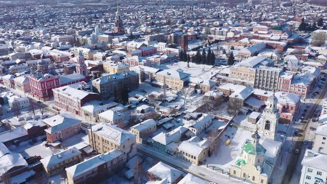 Scenic aerial view of covered with snow houses and churches in Russian city of Yelets on sunny winter day, Lipetsk Oblast