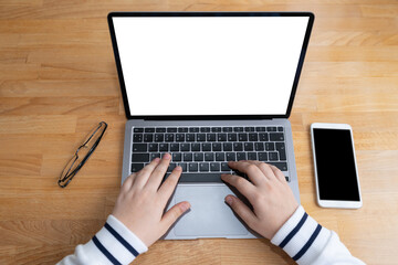 Woman hands on laptop with blank screen and phone. Mock up of computer monitor. Copy space ready for design.