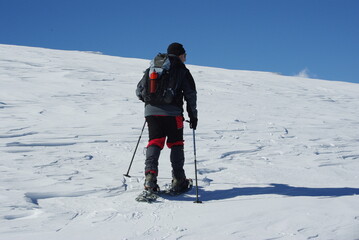 Fototapeta na wymiar climber climbing snowy mountain, with professional equipment