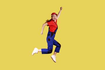 Side view portrait of extremely happy worker woman jumping and clenched fists, celebrating long...