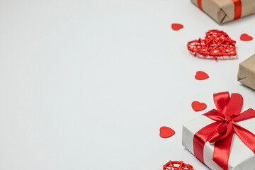 Valentines day concept with gift box and small hearts on white background. Copy space