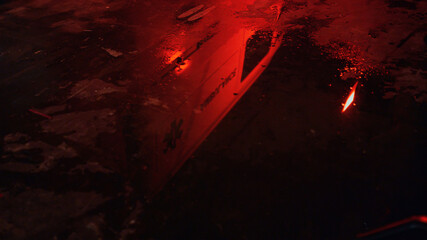 Lights of ambulance car reflecting in puddle. Siren illuminating at night © stockbusters