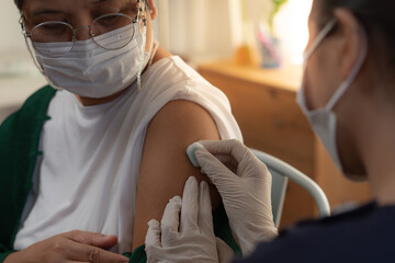 The officer nurse was using a cotton swab moistened with alcohol to wipe the upper arm. to prepare...
