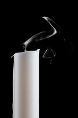 One candle with flame extinguished, smoke, on black background. Closeup. - obrazy, fototapety, plakaty