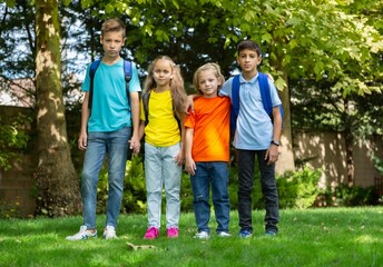 Fototapeta premium Group of schoolchildren walking together on the park