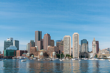 Fototapeta na wymiar Panoramic picturesque city view skyline of Boston Harbour at day time, Massachusetts. An intellectual, technological and political center. Building exteriors of financial downtown.