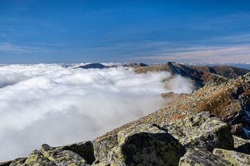 View from the mountain ridge of the Low Tatras. The tops of the mountains protrude above the inverse clouds. 