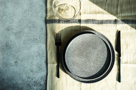 Overhead view of a place setting on a t able with a wine glass and tablecloth