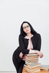 beautiful female teacher at the desk with books for learning