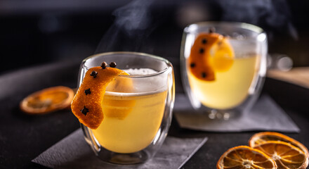 HOT TODDY drink made of whiskey, simple syrup, hot water, cloves and orange zest ready for...