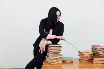 beautiful female teacher at the desk with books for learning