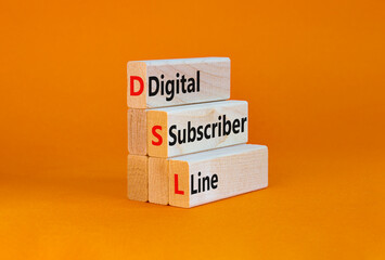 Naklejka premium DSL digital subscriber line symbol. Concept words DSL digital subscriber line on wooden blocks. Beautiful orange table, orange background, copy space. Business and DSL digital subscriber line concept.